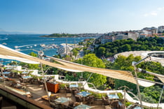 a view of a restaurant with a view of the water