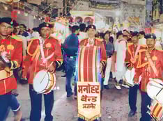 An old photo of the Manohar Brass Band playing clarinet, thap dhol, nagara drum, and shehnai instruments.