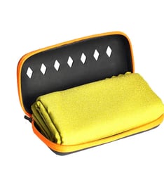 a yellow case with a towel and a towel