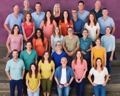 a group of people standing in front of a purple wall