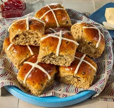 Traditional spiced, sticky glazed fruit buns with pastry crosses