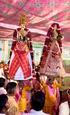 Two women with Gangaur Devi Devta on their heads, accompanied by the Manohar Brass Band.