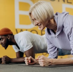 a woman is doing push ups on a mat