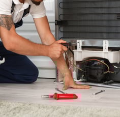 technician doing fridge service