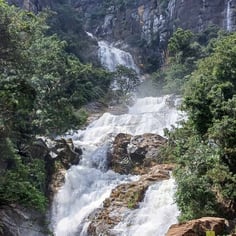 Rawana Waterfall near Ella, Sri Lanka, cascading down rocky cliffs surrounded by lush greenery