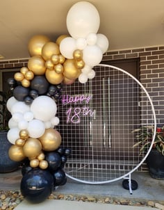 White mesh circle backdrop hired with a black white and gold balloon garland setup for 18th Birthday in Logan.