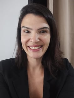 a woman with a black jacket and earrings