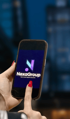 Person holding a smartphone with NexaGroup logo on screen, representing digital solutions and brandi