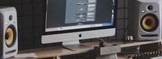 a computer monitor monitor and speakers in a room