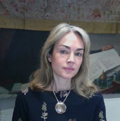 a woman in a black dress and necklaces