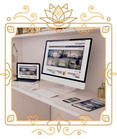 two computers, a phone and an iPad on a desk in a victorian frame