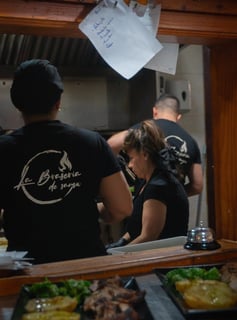 a man and woman in a restaurant kitchen