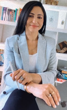 a woman sitting on a chair with a laptop