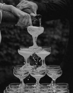 a man and woman are pouring champagne into glasses