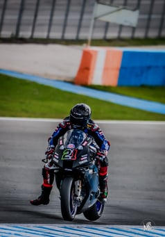 a person riding a motorcycle on a track