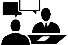 a man and woman sitting at a desk with speech bubbles
