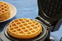 a waffler on a plate with two waffles on it