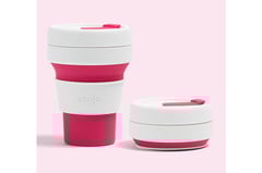 a cup of coffee with a pink cupcake on top of it