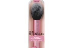 a pink makeup brush with a brush and a brush