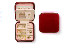 a red velvet case with jewelry inside