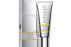 a white box with a silver and gold tube and a white box with a silver