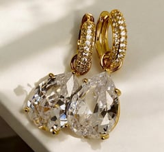 a pair of earrings with a gold earring