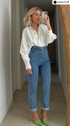 a woman in a white shirt and jeans jeans