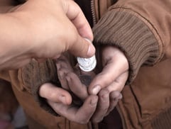 a person holding a pill pill in their hands