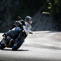 a person riding a motorcycle on a road
