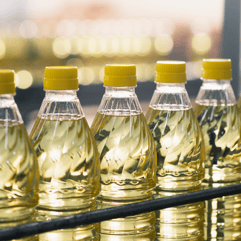 a row of bottles of oil on a shelf
