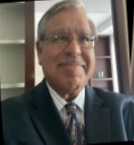a man in a suit and tie smiling