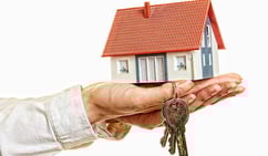 a person holding a keychaik in their hand