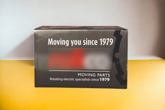 Corrugated folding carton for moving parts