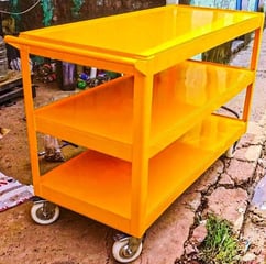 A yellow trolley has 3 shelf.