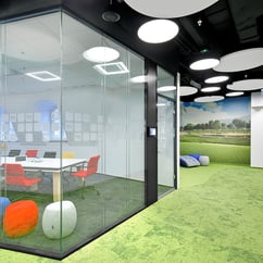 sala de reuniones acristalada y alfombra verde
