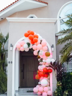 a colorful arch shaped balloon - shaped arch with balloons