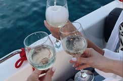 Guests toasting at sunset during a romantic boat tour with Balea Charters in Mallorca