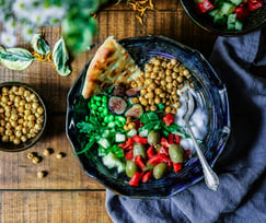 a bowl of food with a fork and a spoon