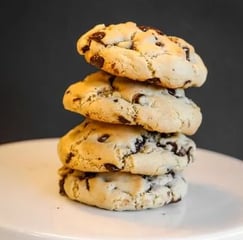 a stack of cookies and chocolate chip cookies on a cake plate