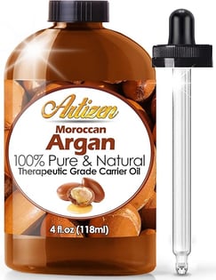 a bottle of argan oil with a glass bottle of argan oil