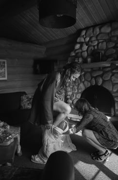 Bride stepping into dress in the Alpine Village cabins