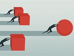 a man is pushing a giant red object in a line