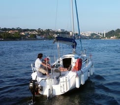 Our sailboat Monark cruising on the Douro River on a sunny day