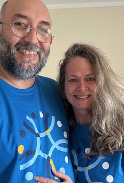 a man and woman in matching blue shirts