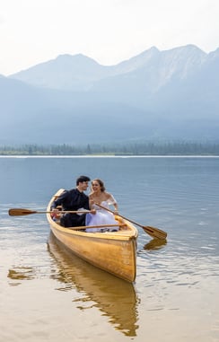 a man and woman in a canoe on a lake