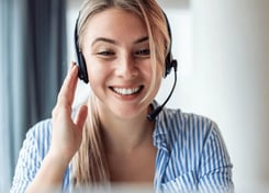 Friendly real estate photography customer support agent assisting a client via headset