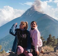 Eva and Manon in front of the eruption of Fuego Volcano, Guatemala.