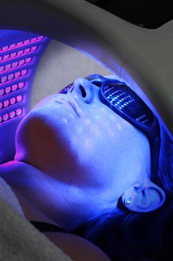 Woman having blue LED light therapy of face, anti-aging therapy, acne, skin rejuvenation, skin inflammations