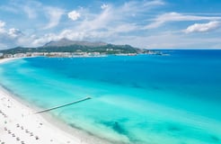 Scenic view of Alcudia Bay on a clear day, popular boat tour destination in Mallorca
