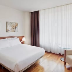 Spacious hotel room with double bed included in padel camp package